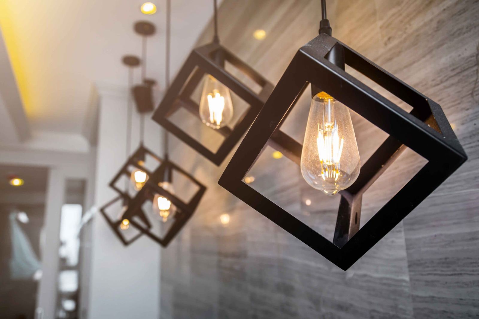 Finished commercial interior with feature pendant lighting and a stone clad wall
