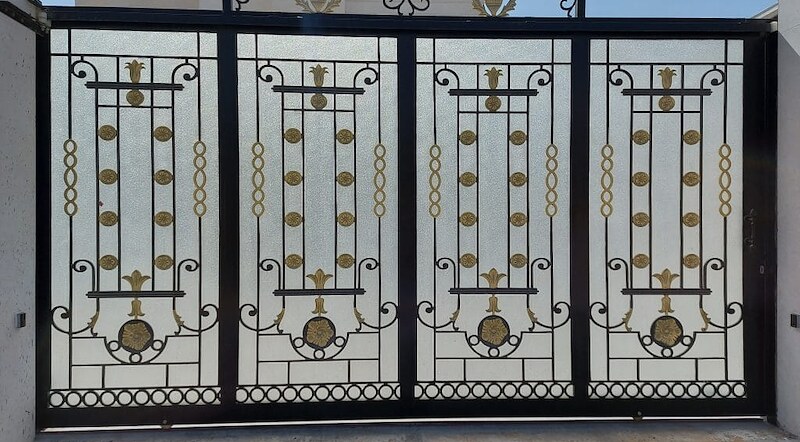 Wrought iron sliding gate with decorative panels