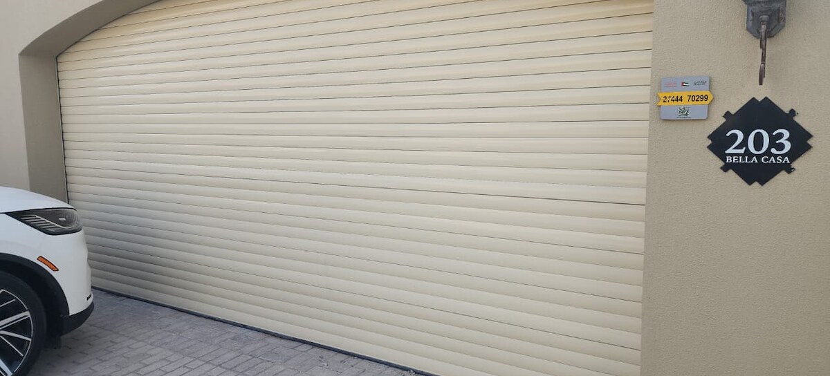 Cream roller shutter garage door fitted to a villa entrance